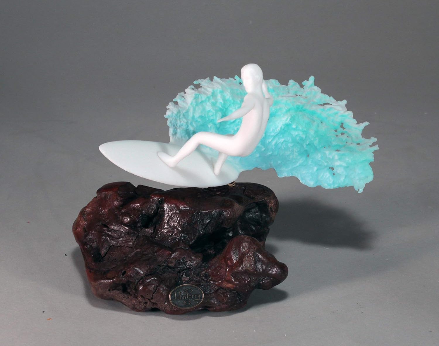 Surfer Sculpture by John Perry 7in Long on Polished burlwood Base. Signed.