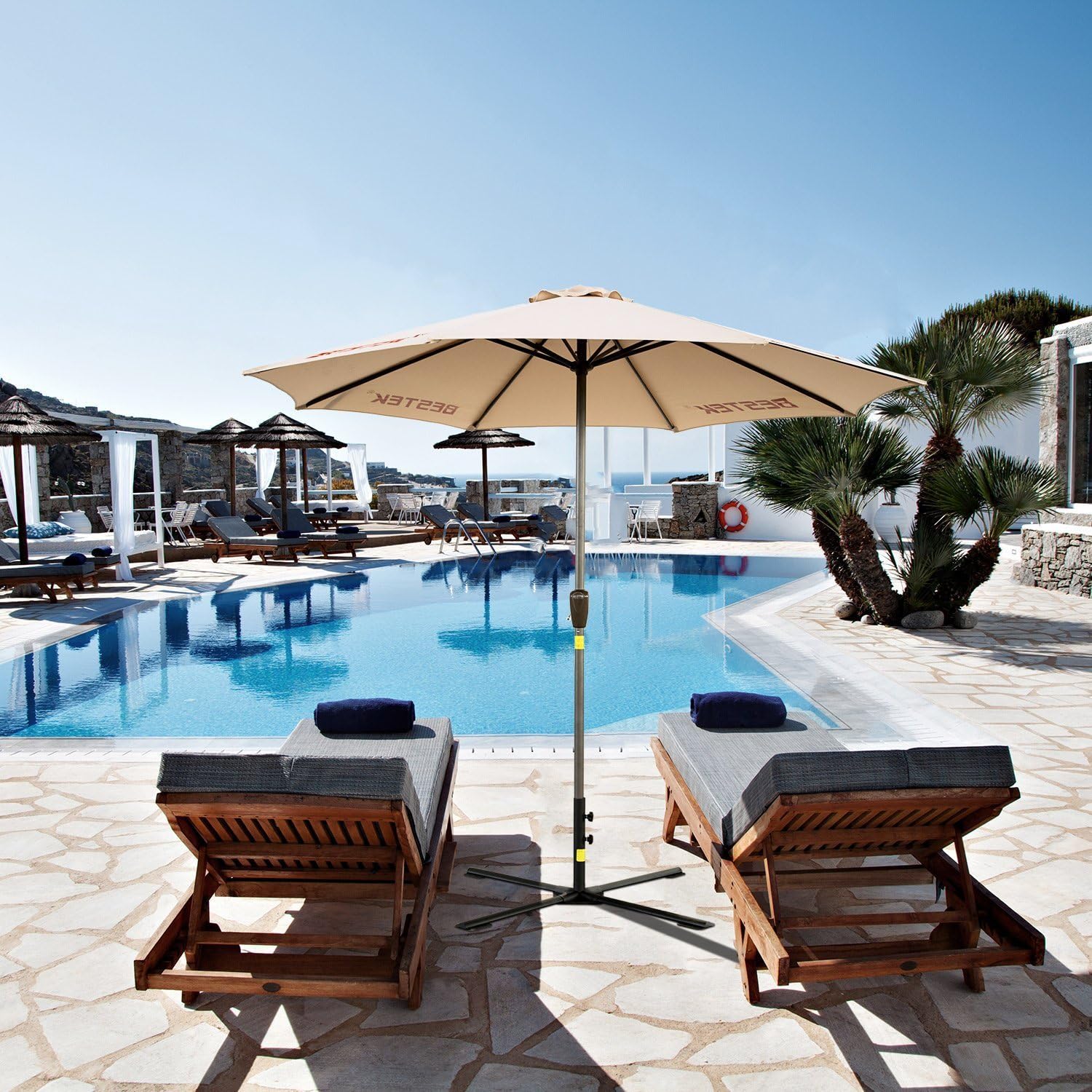 BESTEK Umbrella Base with an umbrella installed next to a swimming pool