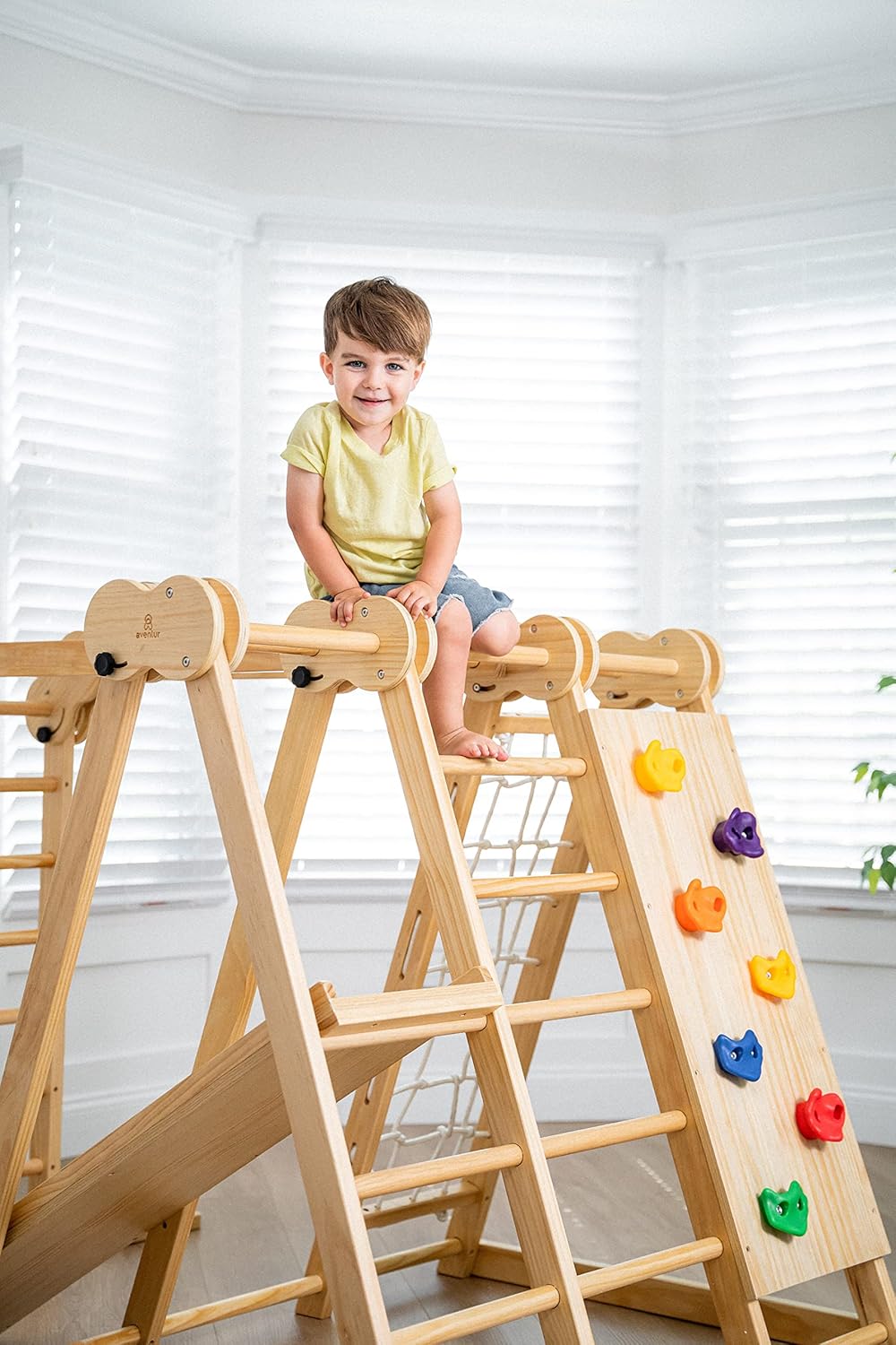 Avenlur 7-in-1 Indoor Playset with rock climbing wall attachment, no children present.