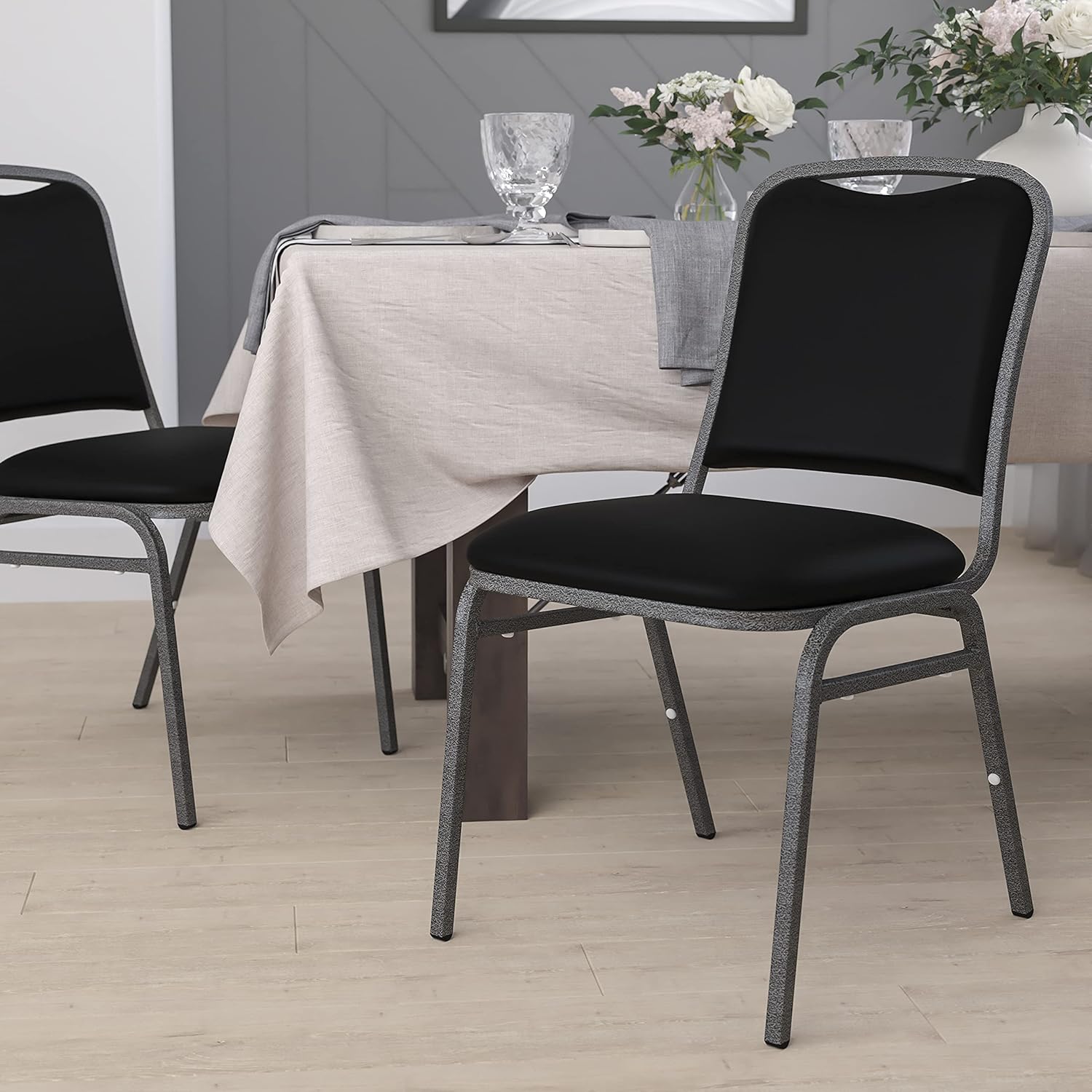 EMMA + OLIVER Stacking Banquet Chair in Black Vinyl - Silver Vein Frame