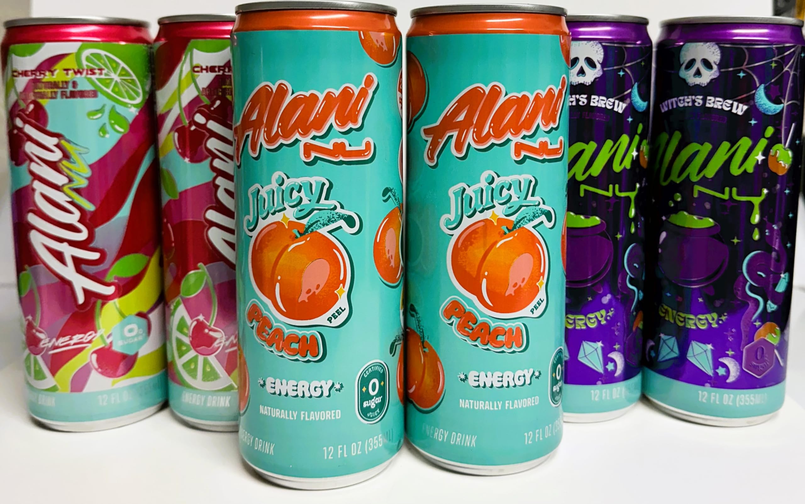 Generic Alani Energy Drinks 3 of a kind - A Taste of 3 Worlds. 6 120z Cans with 2 of 3 Flavors: Witches Brew, Juicy Peach, and Cherry Twist