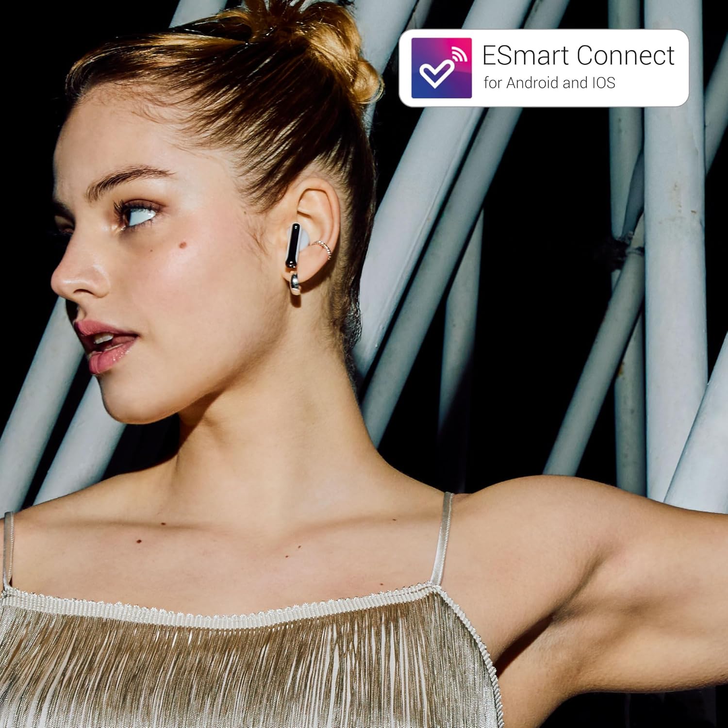 Person wearing an Energy Sistem StyleBuds earbud, illustrating ESmart Connect app functionality.