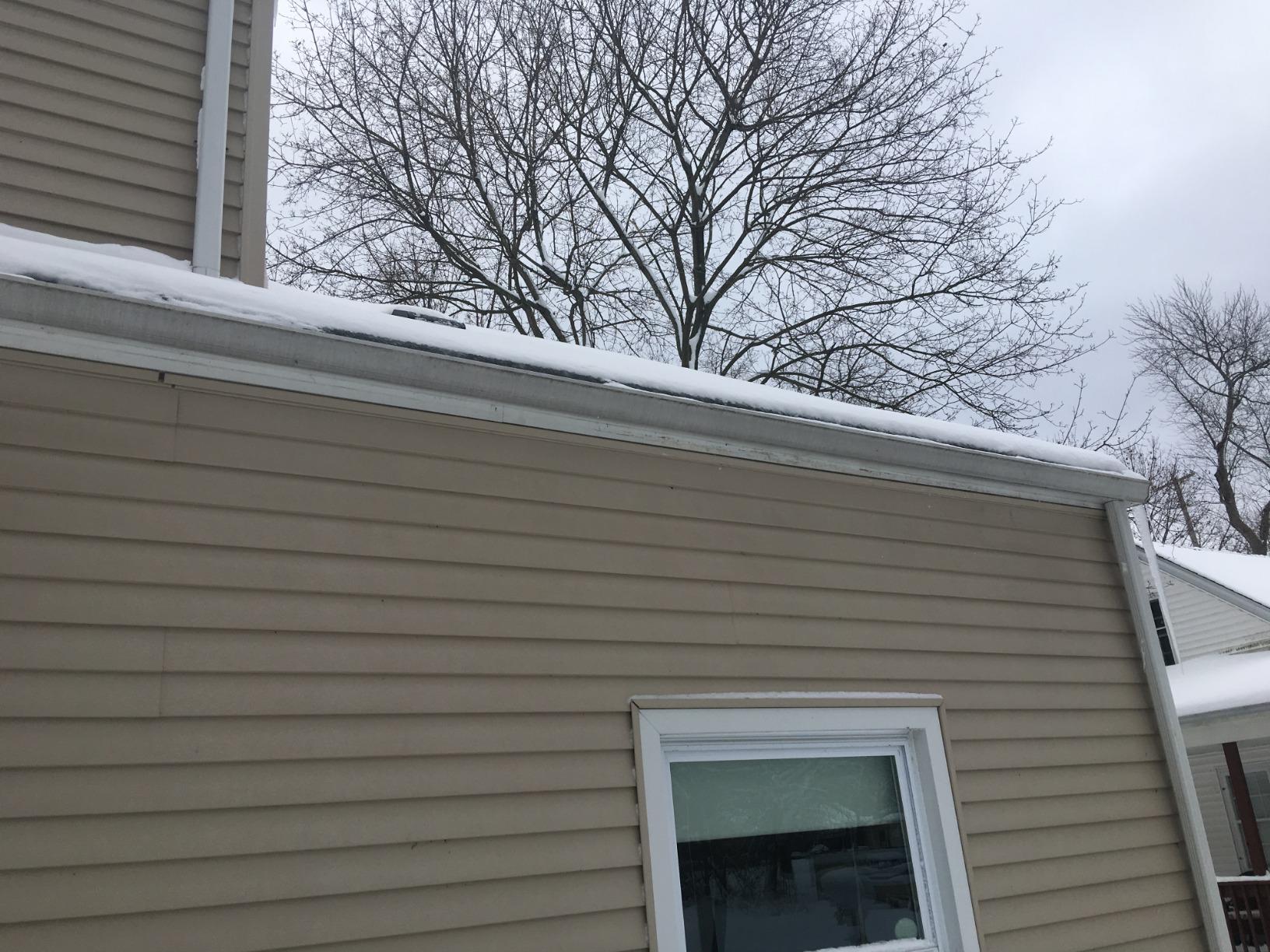 Ice buildup on a garage gutter without deicing cable