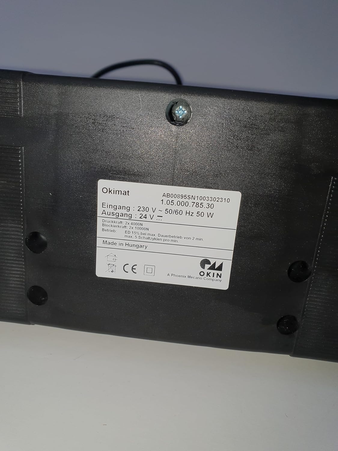 Close-up of the OKIN OKIMAT motor label showing specifications