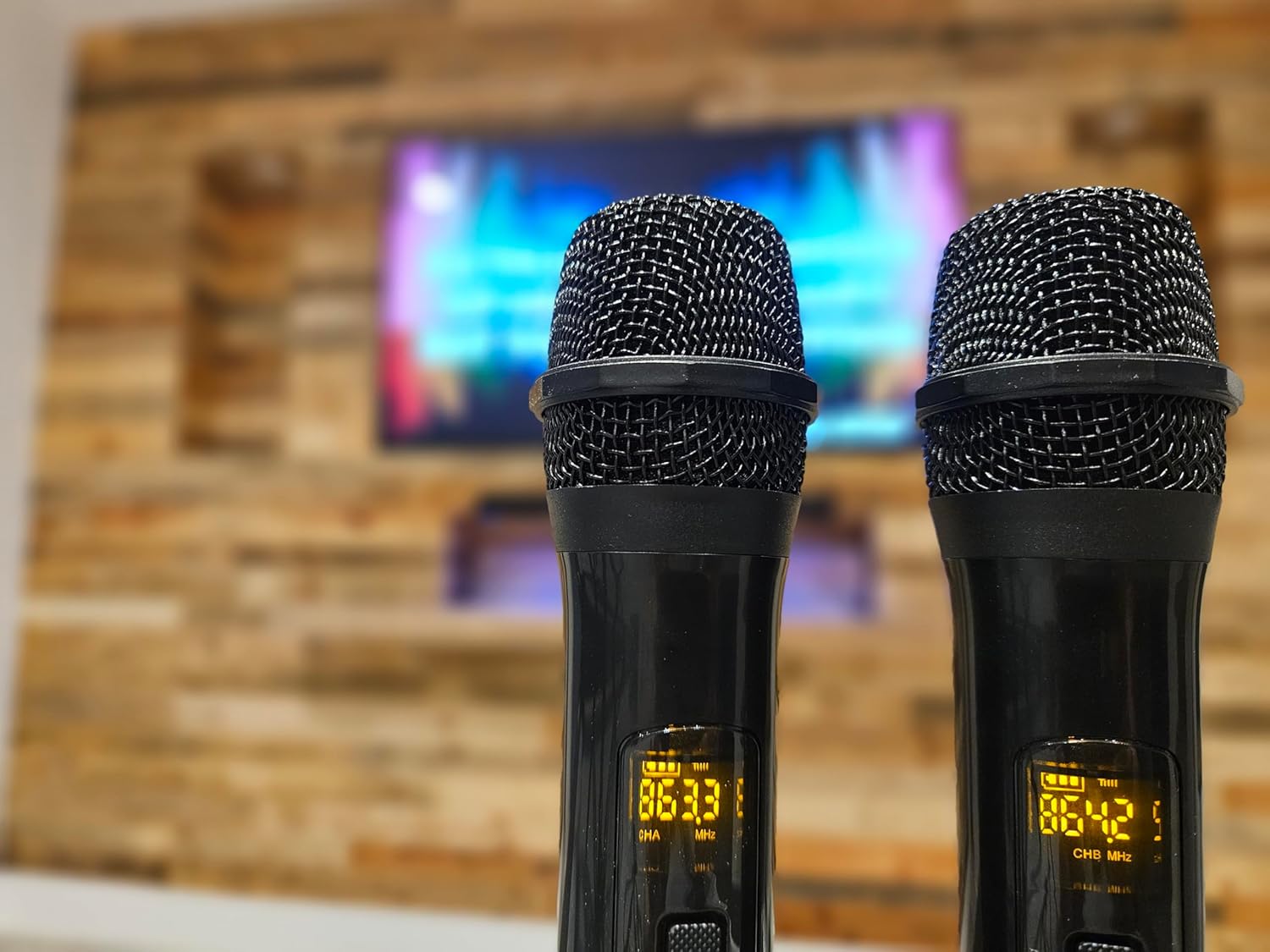 Close-up of two wireless UHF microphones with digital displays
