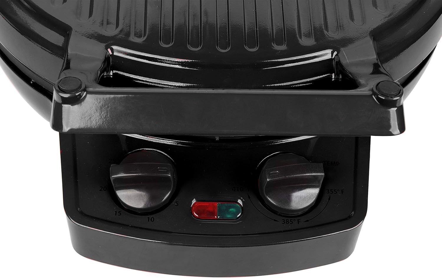 Close-up of the Courant Pizza Maker's control panel with temperature and timer knobs.