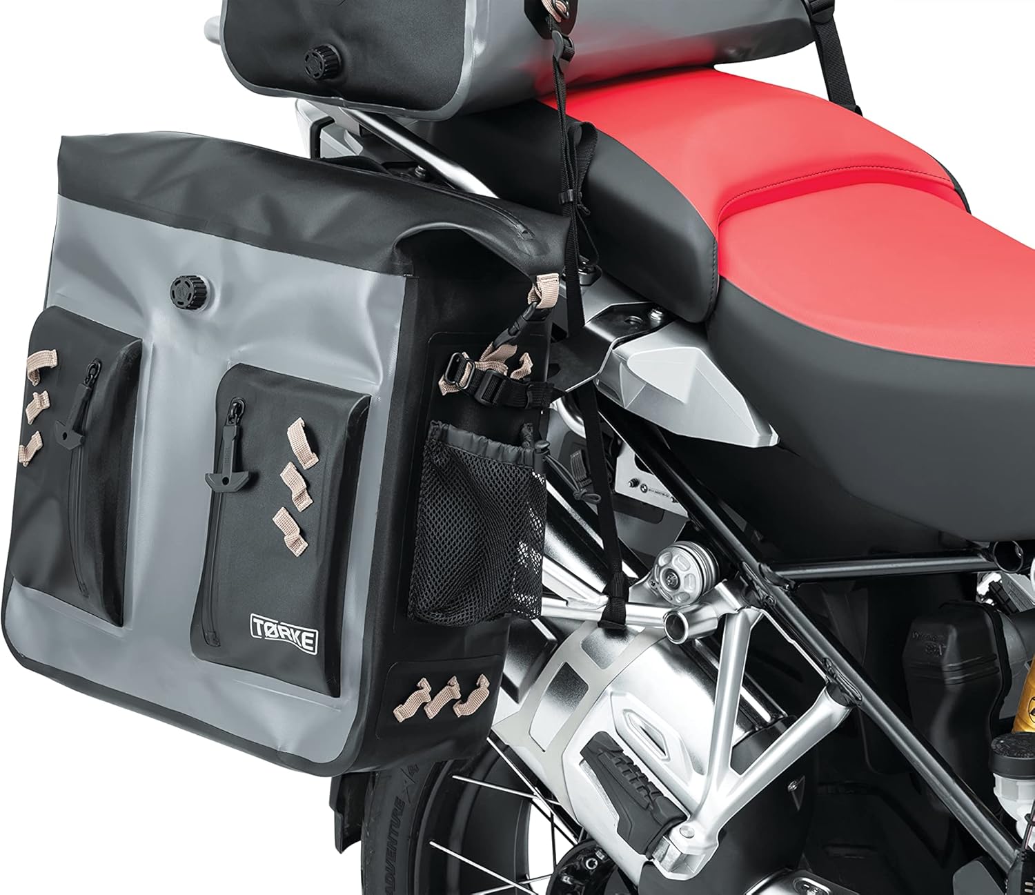 Kuryakyn Tørke pannier mounted on a motorcycle with the black external cargo net installed on top, securing additional items.