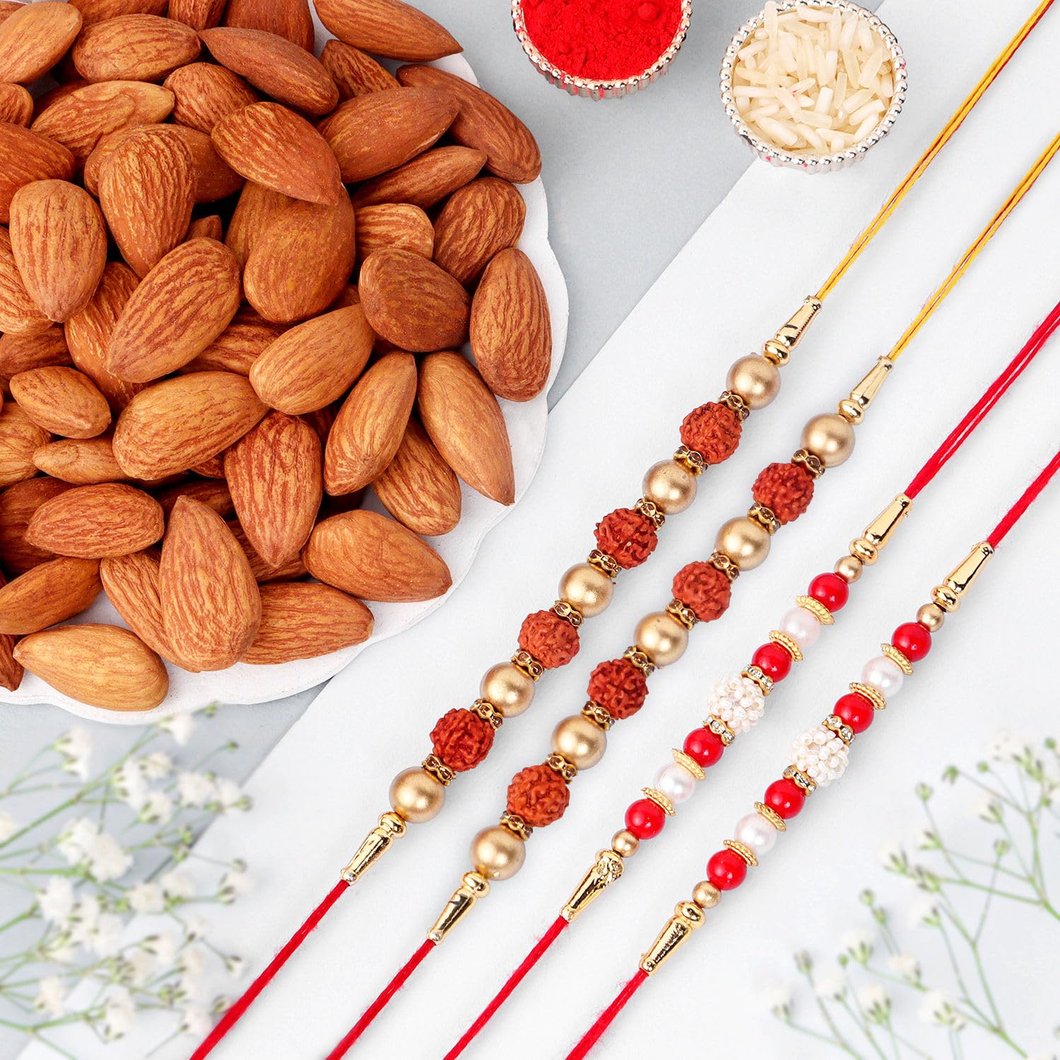FNP Set of 4 Rakhi Gift Hamper with Rudraksha & Pearl Rakhis, Almonds (100g) & Roli Chawal Raksha Bandhan Combo for Brothers-image-12