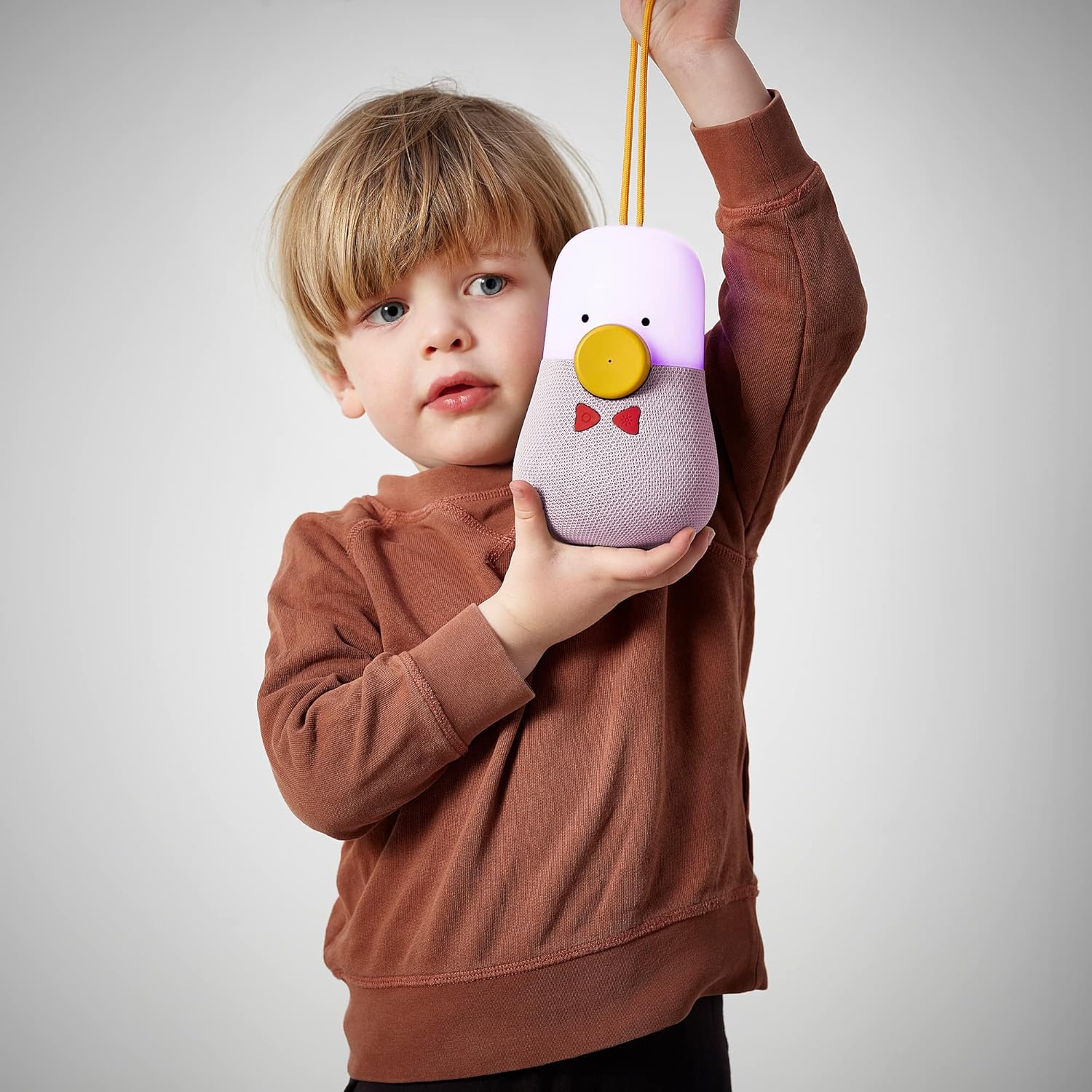 Child interacting with speaker buttons