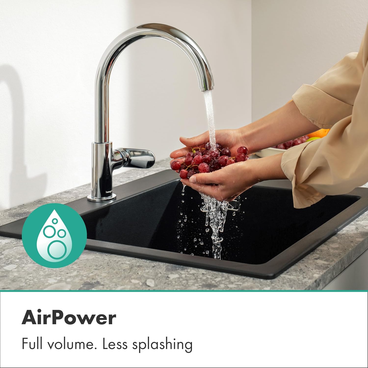 Hands washing grapes under the Hansgrohe Vernis Blend M35 Kitchen Mixer, demonstrating the AirPower function with a full, soft water jet.