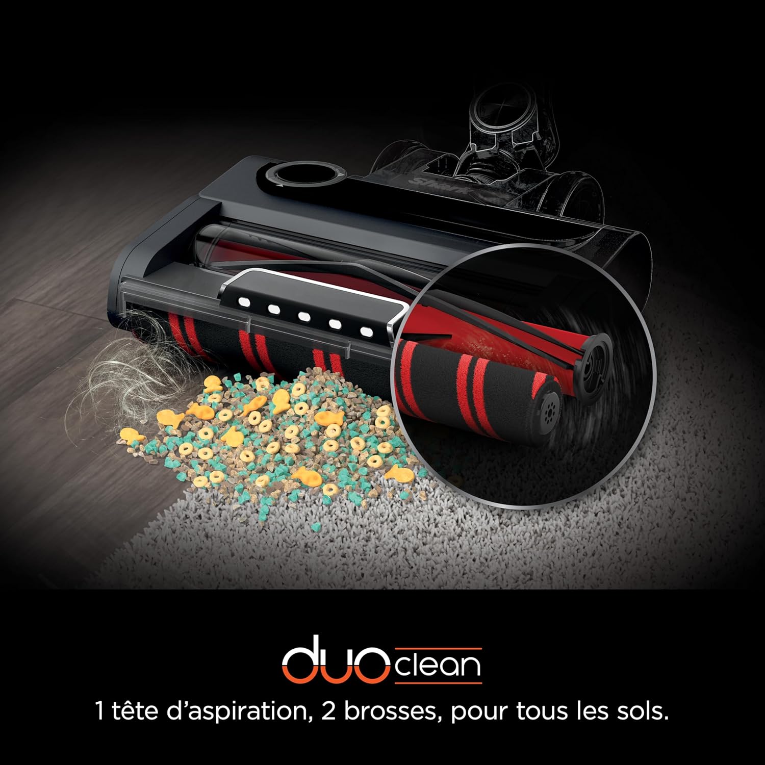 Close-up of the DuoClean PowerFins Plus brush-roll system on a carpet, showing effective debris pickup.