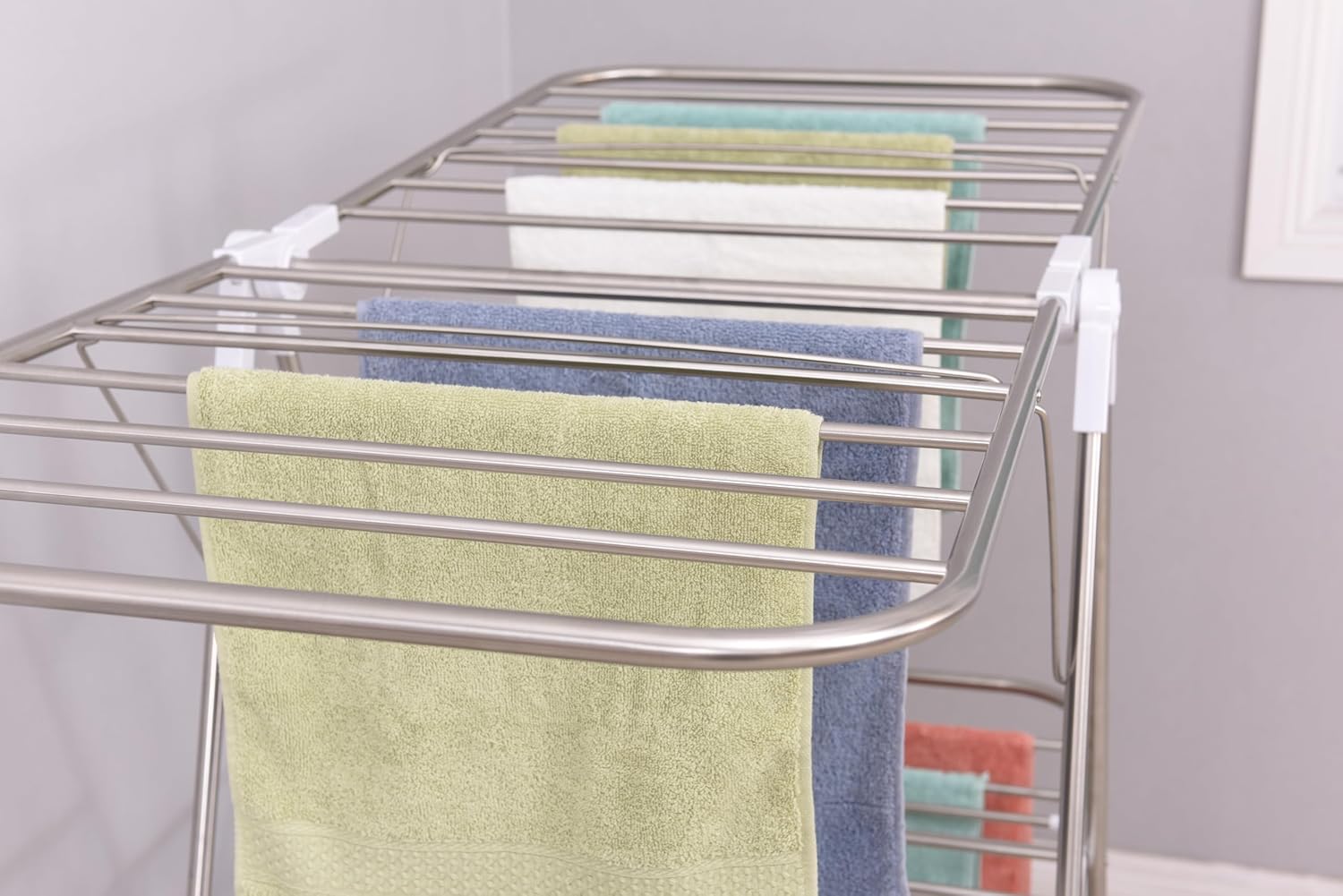 Close-up of the white plastic joint mechanism on the EZHOME laundry rack, showing how the side wings pivot and lock into place.