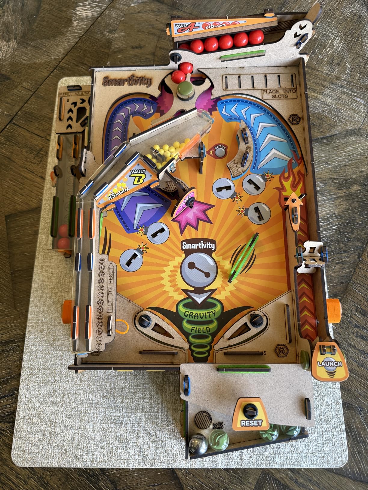 Top down view of the Smartivity pinball machine showing the playing surface with obstacles and scoring areas