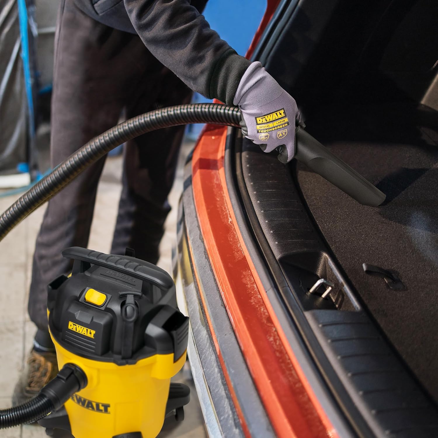 Person vacuuming car interior with DEWALT DXV06PL