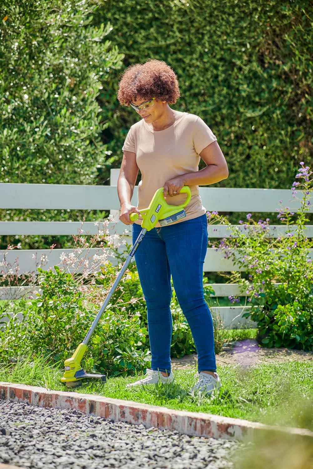 Man using the RYOBI edger to trim grass