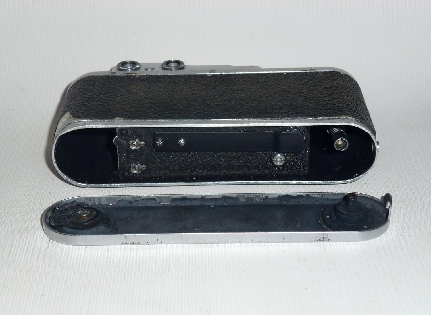 Zorki-1 camera with its bottom plate removed, revealing the film compartment.