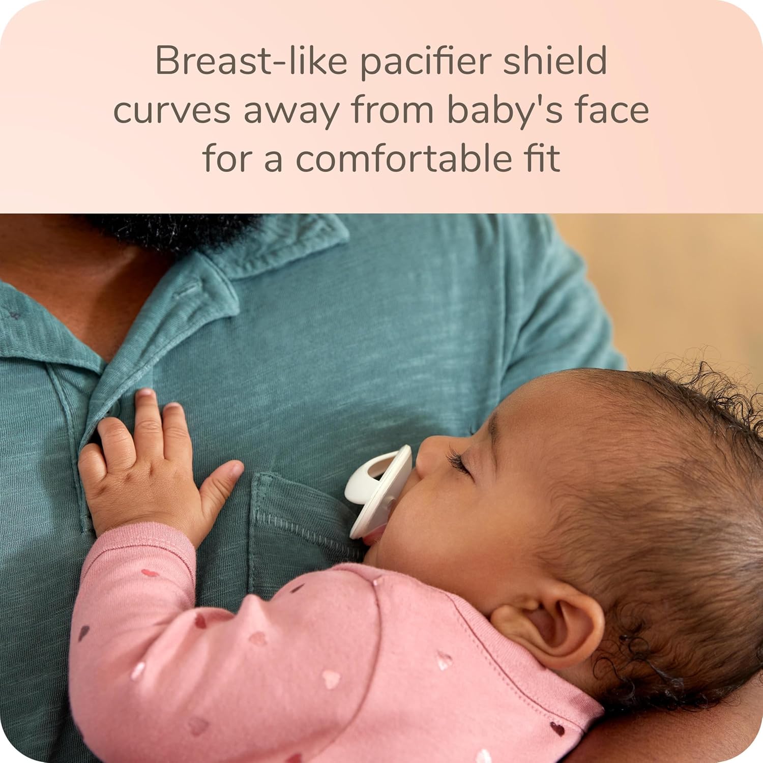Baby sleeping with NUK Simply Natural Pacifier, showing the shield curving away from the face