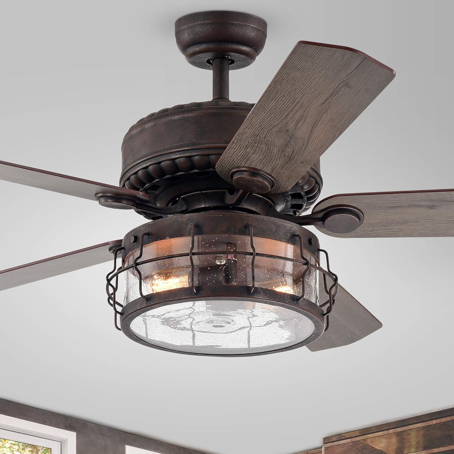 Close-up view of the caged drum shade and light kit on the ceiling fan