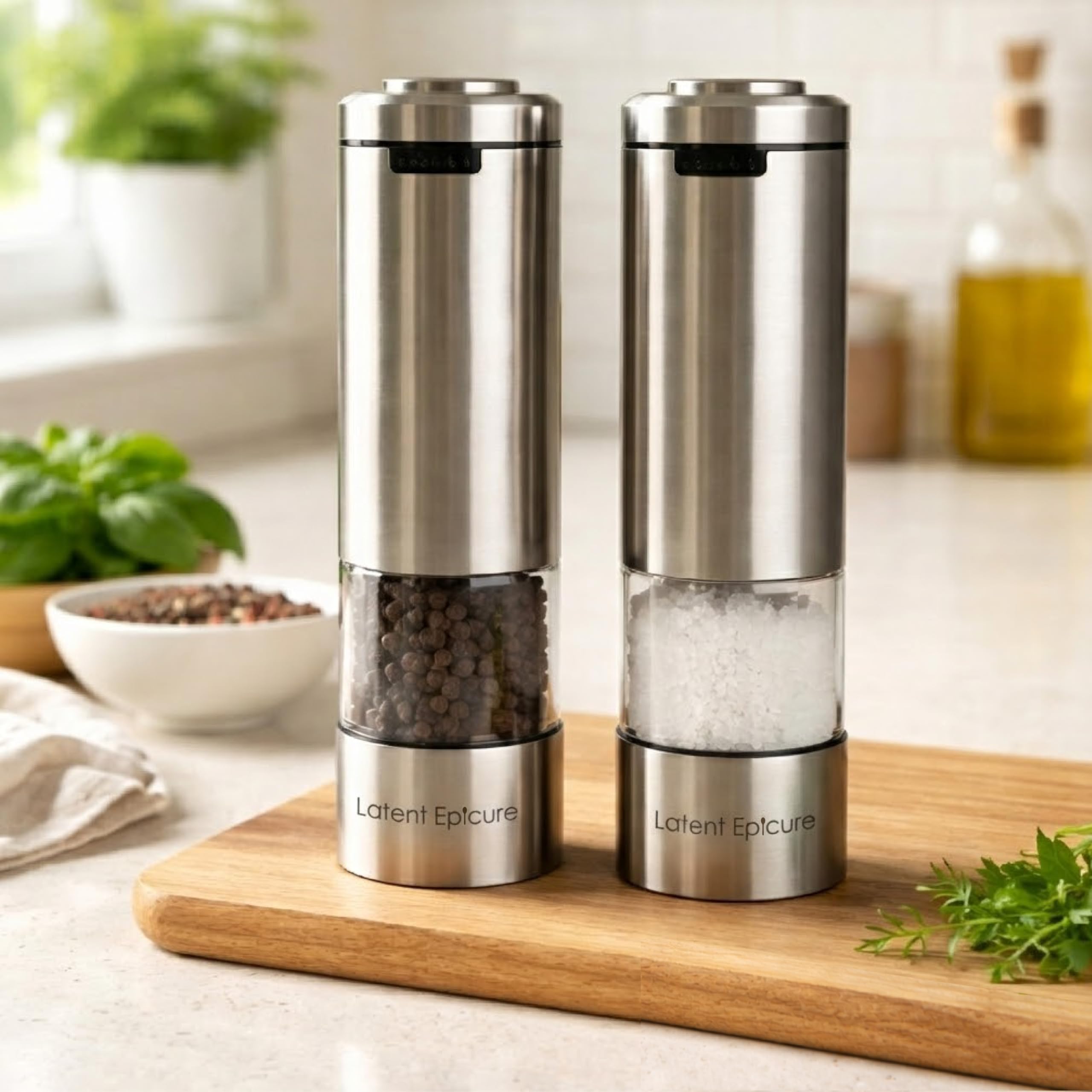 Close-up of the Latent Epicure electric salt and pepper grinders on their acrylic rest tray.