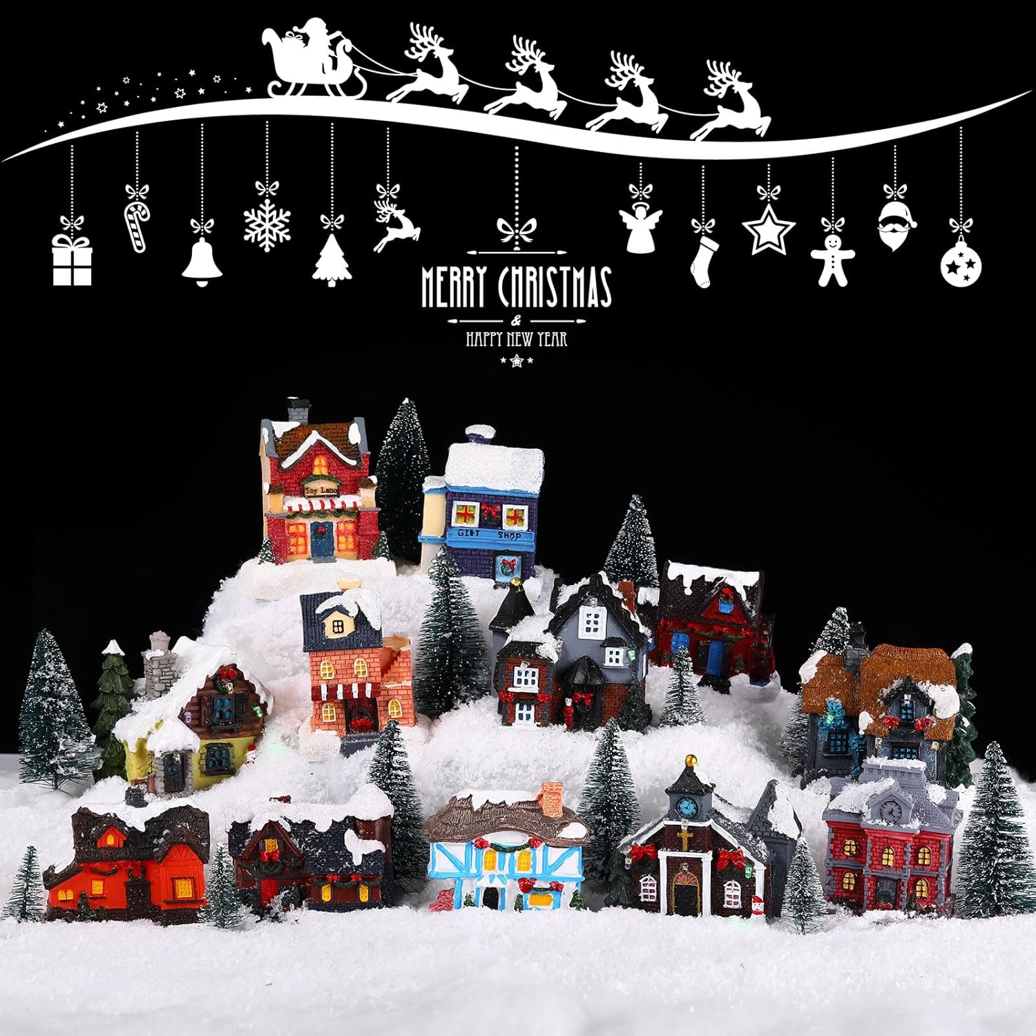 Image showing a Kajaia Christmas village set arranged on a snowy display with various houses and trees.