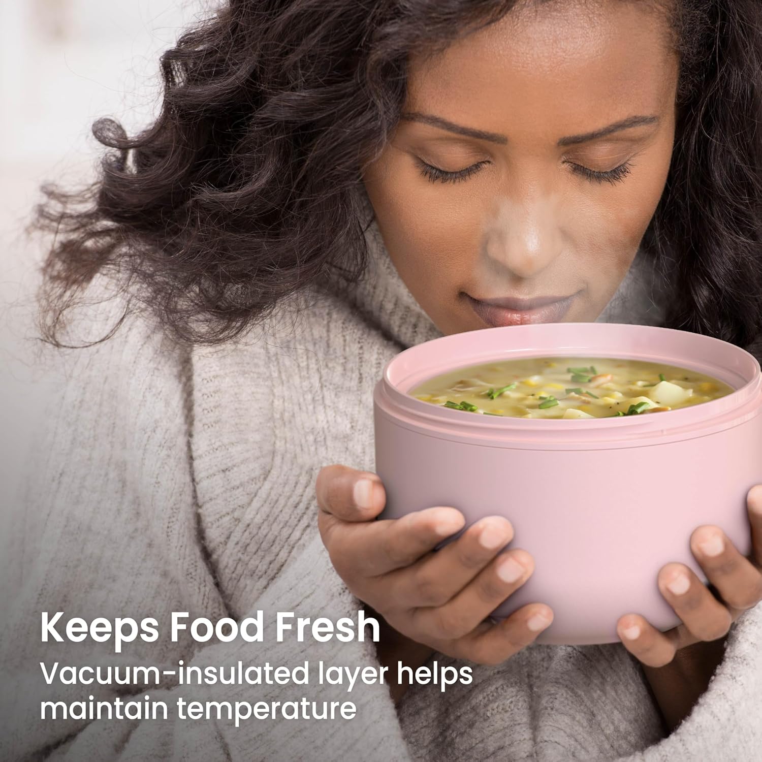 A person holding the Bentgo Bowl, which is filled with soup, demonstrating its ability to keep food fresh and maintain temperature.