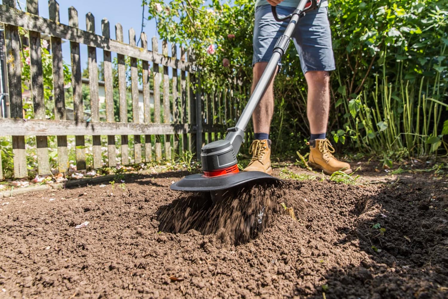 Close-up of AL-KO Cordless Tiller blades cultivating soil