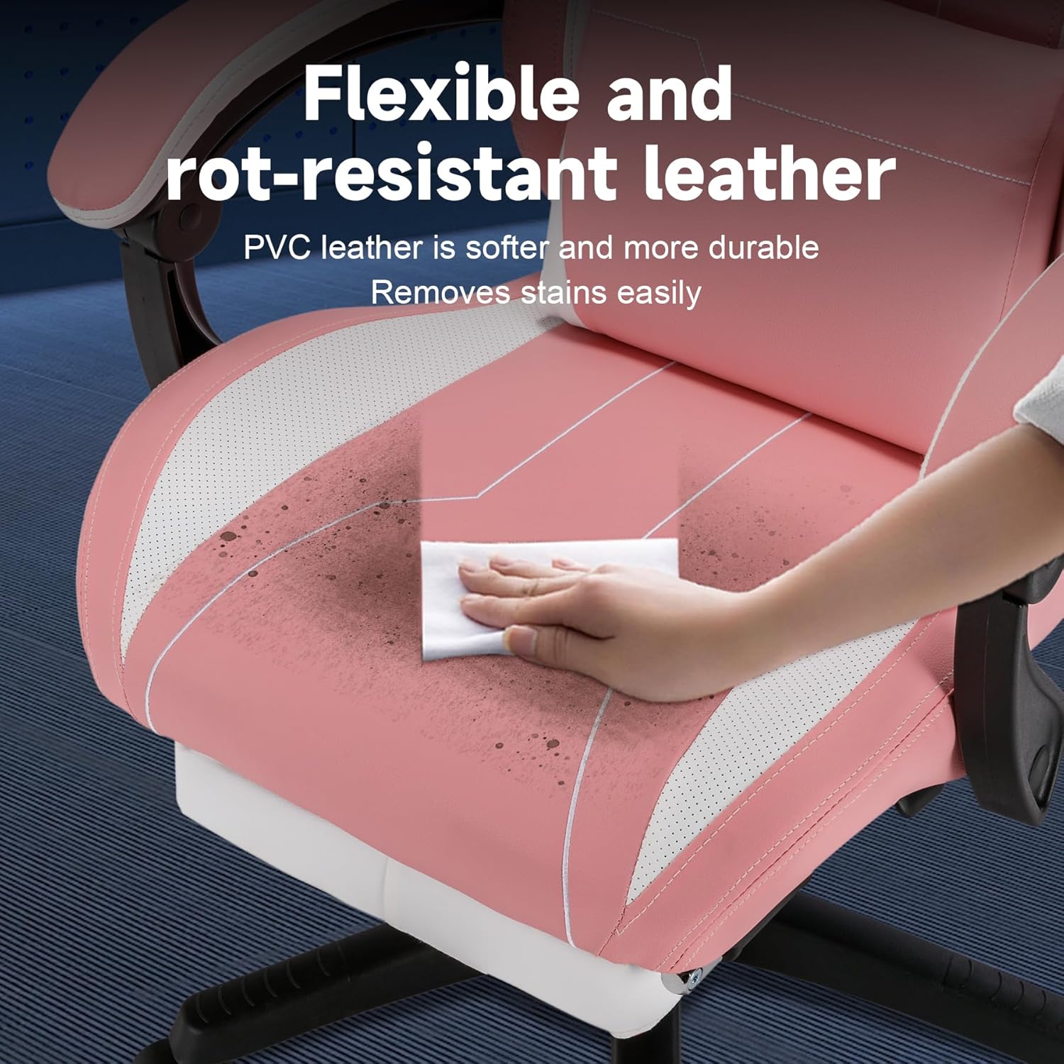 Hand wiping a stain off the pink PVC leather of the chair, demonstrating its easy-to-clean surface.