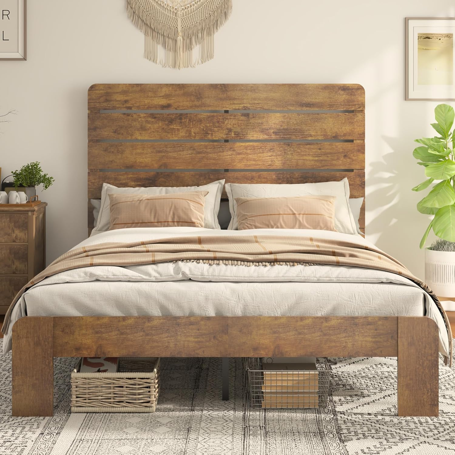 A fully assembled Queen bed frame with a mattress and bedding, showing baskets stored underneath the bed, highlighting the under-bed storage space.