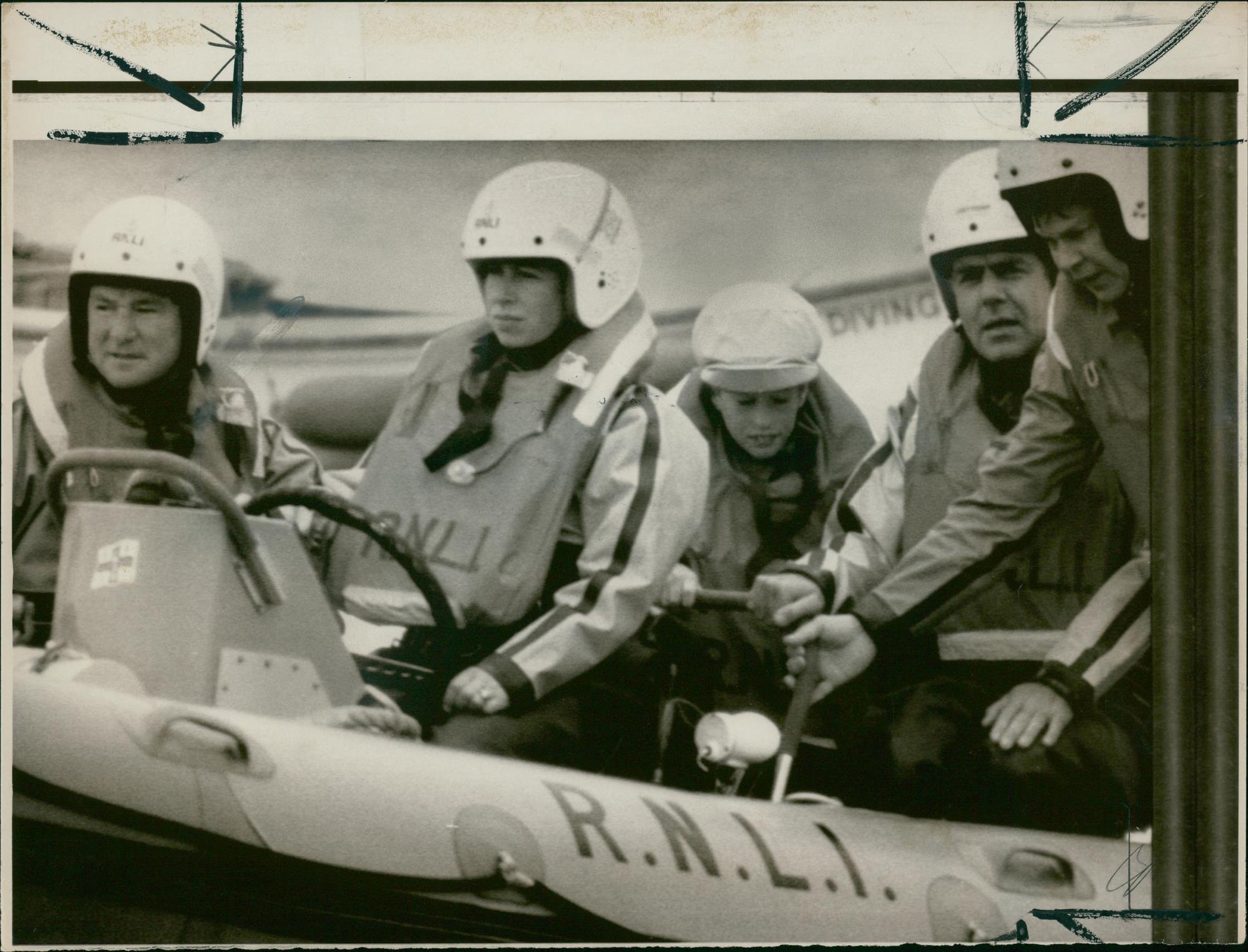 Vintage photo of Princess Anne at the wheel of an RNLI lifeboat.