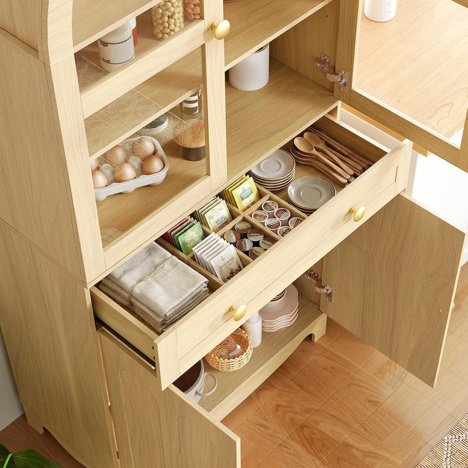 Nærbilde view of the HOOBRO arched pantry cabinet's internal storage, showing a deep drawer with organizers and lower cabinets with items stored.