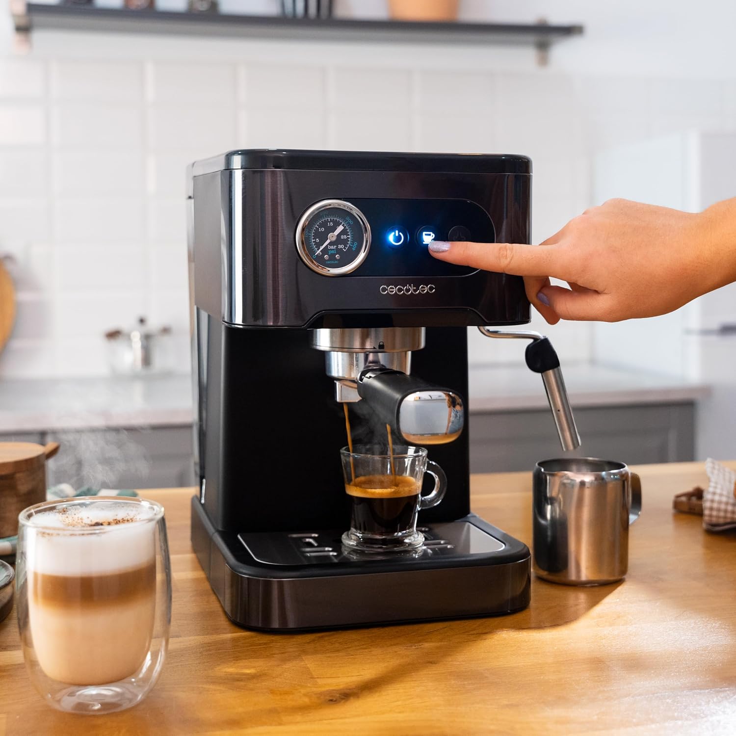 Close-up of the Cecotec Power Espresso 20 Pro Latte machine brewing espresso into a glass cup, showing the control panel and pressure gauge.