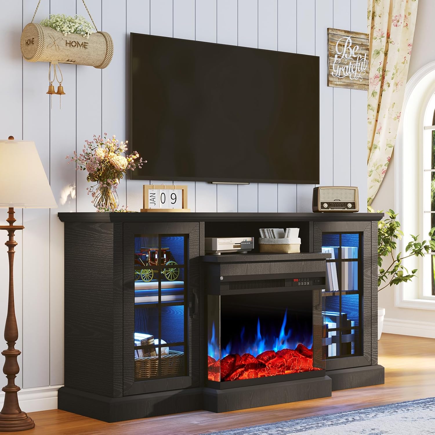 OneBlis 59-inch Fireplace TV Stand in black, with a TV mounted above and decorative items.
