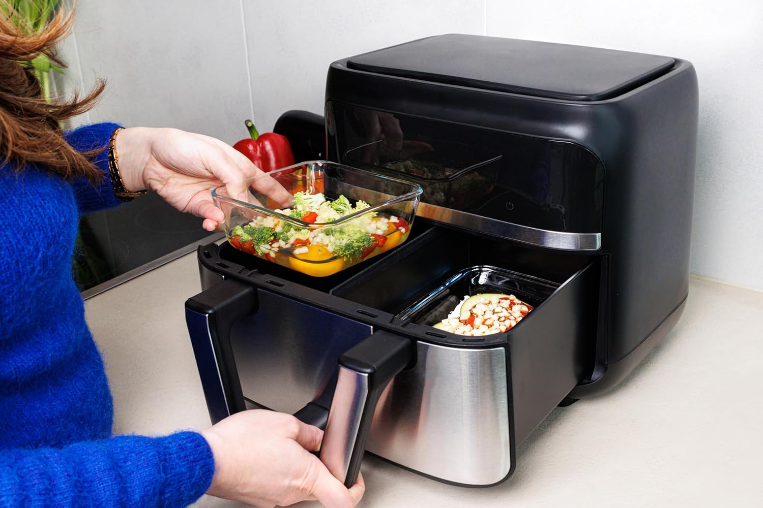 Pyrex glass dish being placed into an air fryer
