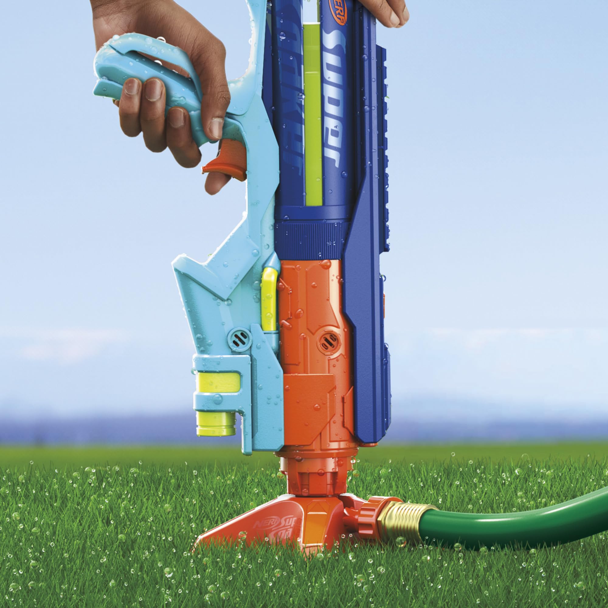 The Nerf Super Soaker Power Drench Water Blaster being pressed onto the Easy Fill Station, which is connected to a garden hose.