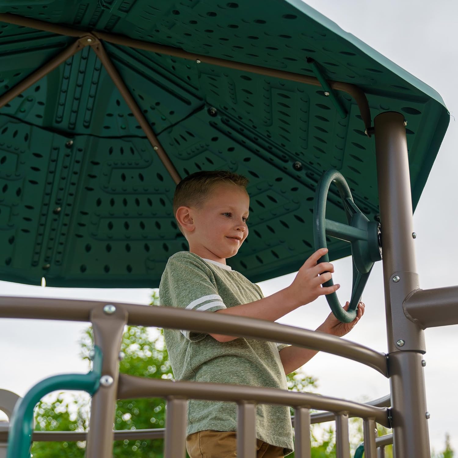 Child playing with the steering wheel in the clubhouse