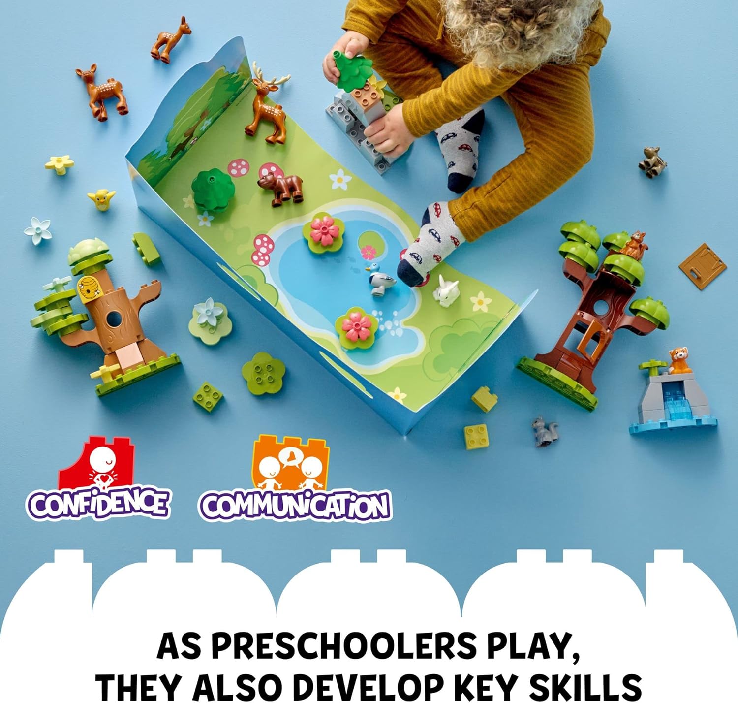 Child playing with LEGO DUPLO set, arranging animal figures and building blocks