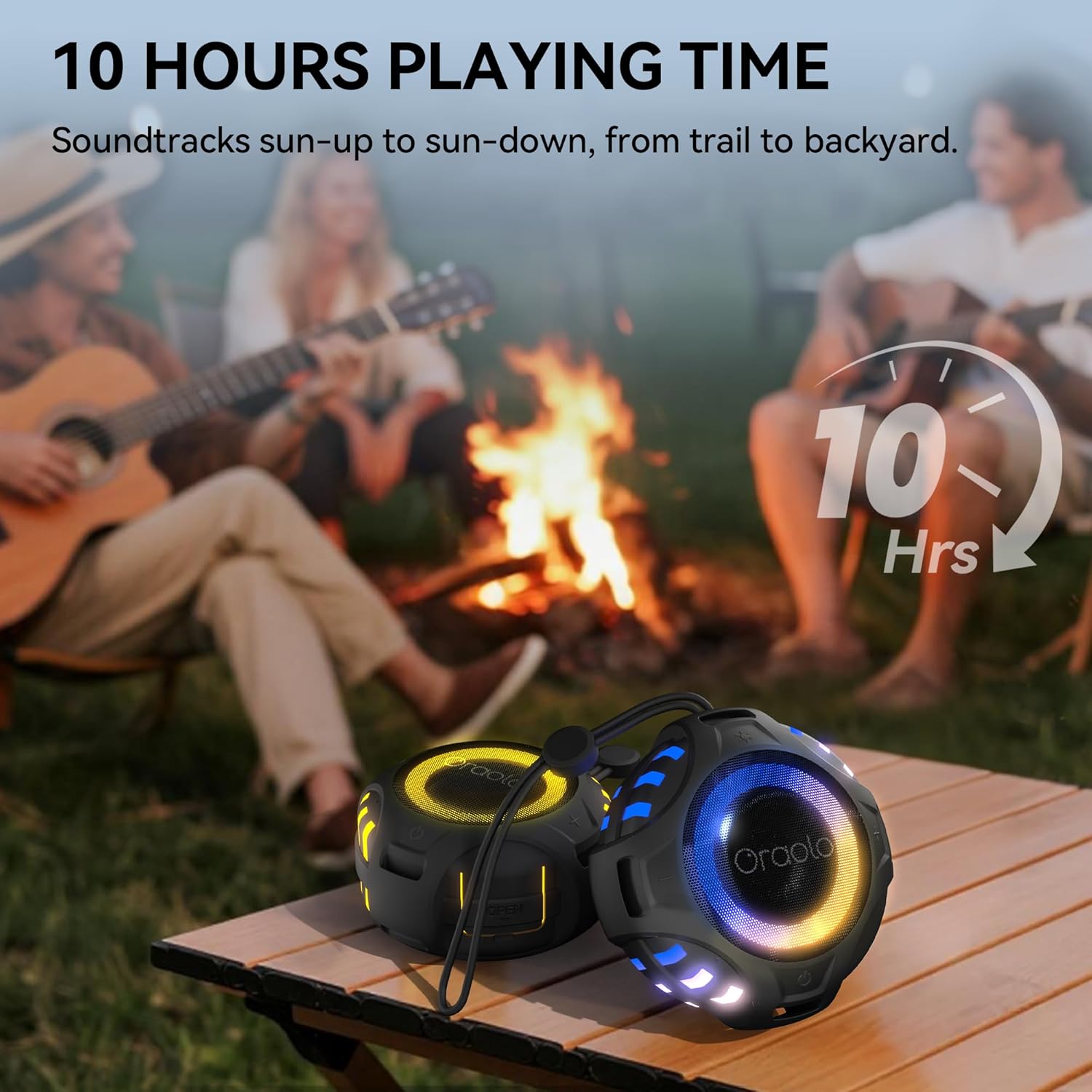 Two Oraolo BS15 speakers placed on a wooden table during a camping scene, illustrating the TWS pairing feature for stereo sound.