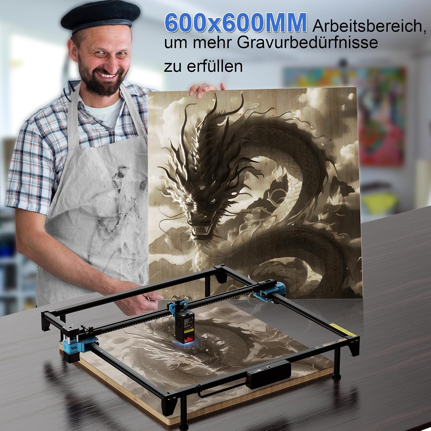 Man holding a large engraved wooden dragon artwork next to the Twotrees TTS-20 Max laser engraver
