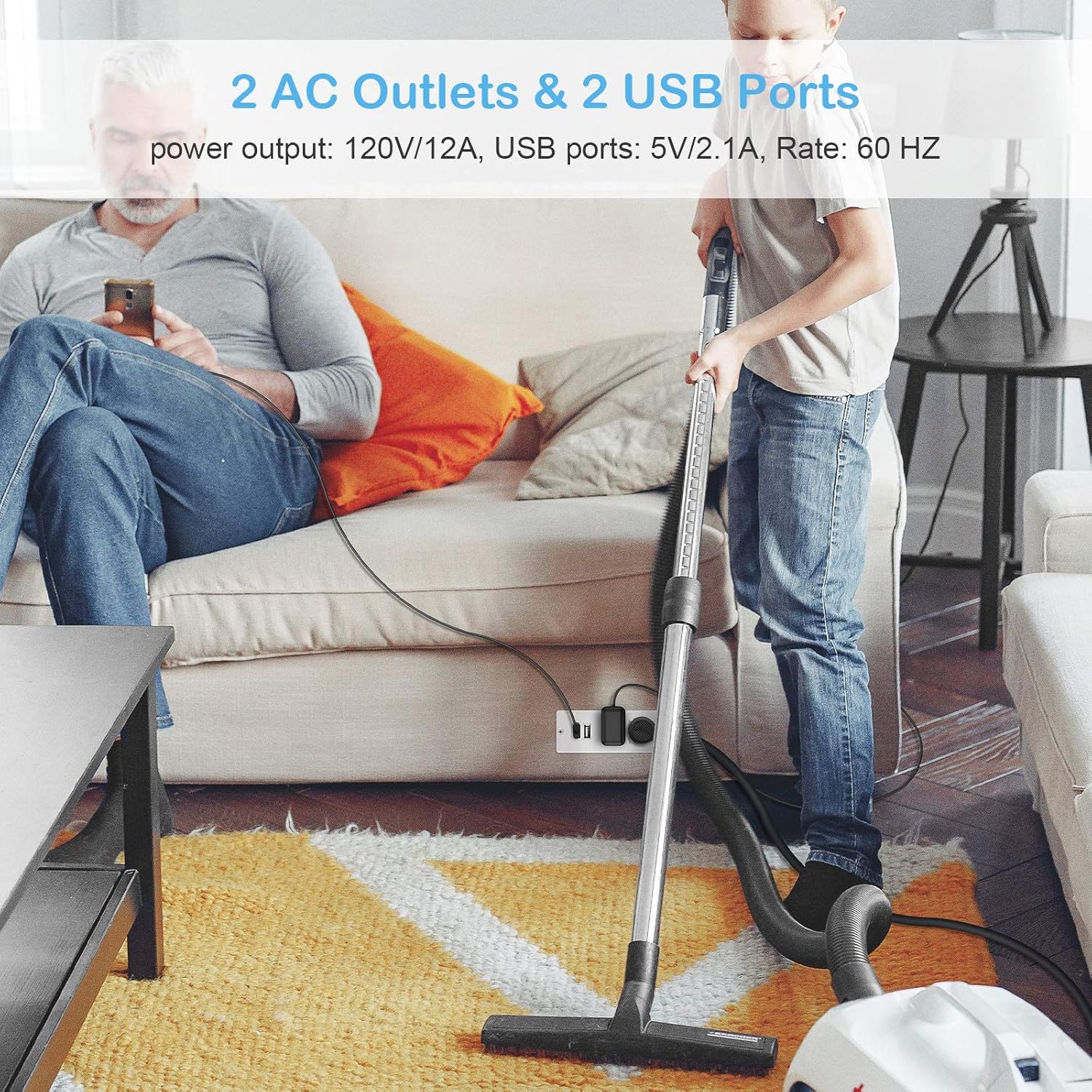 A person using the recessed power strip to charge a phone via USB and power a vacuum cleaner via an AC outlet.