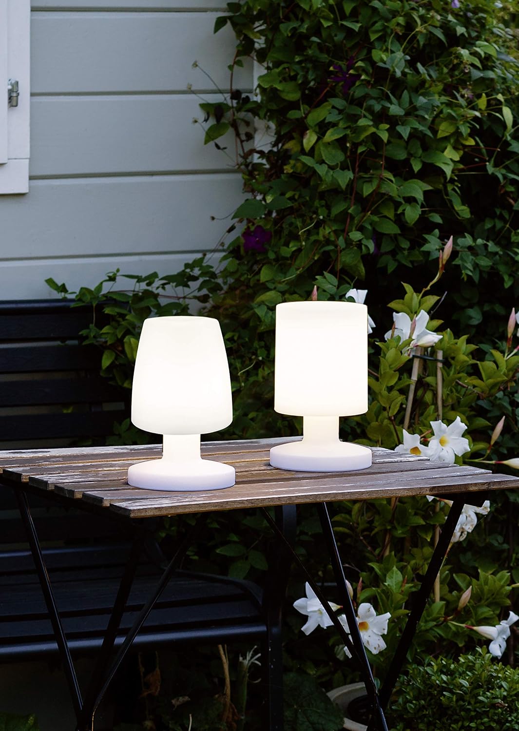 Two Dora lamps on an outdoor wooden table