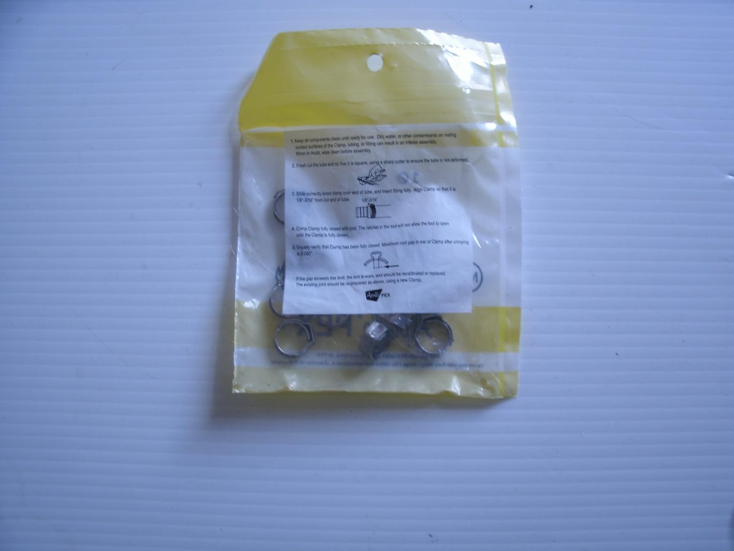 Image showing the back of the Apollo PXPC3810PK clamp packaging with installation instructions printed on it.