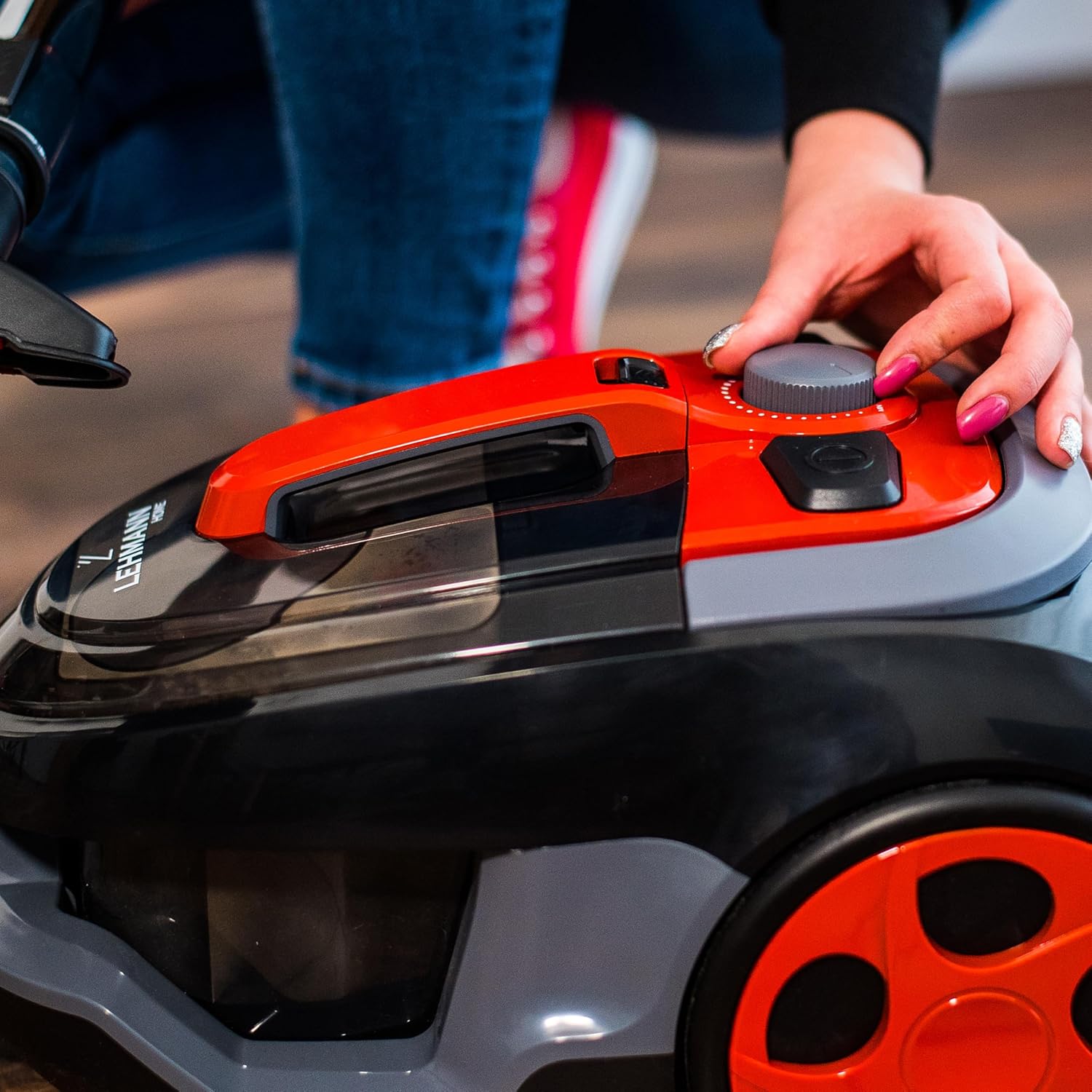 Hand adjusting the power dial on the Lehmann Typhoon vacuum cleaner