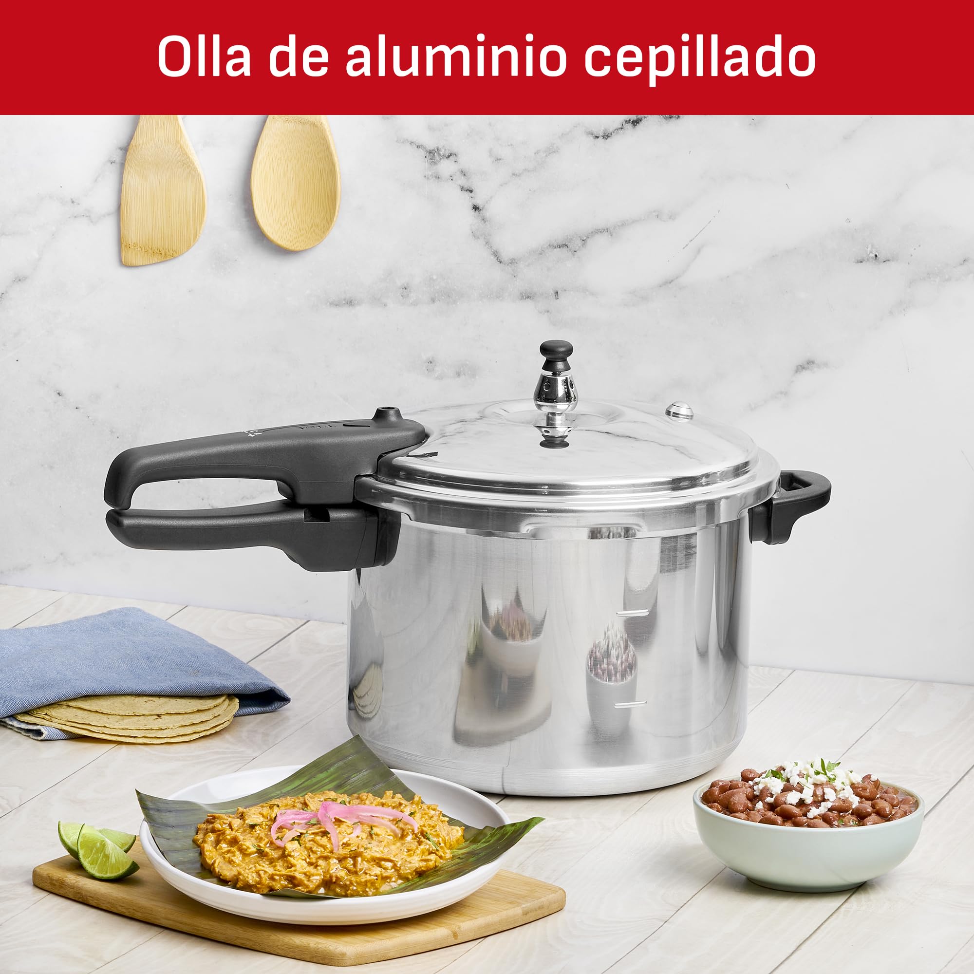 T-fal pressure cooker made of brushed aluminum, showcasing its metallic finish.
