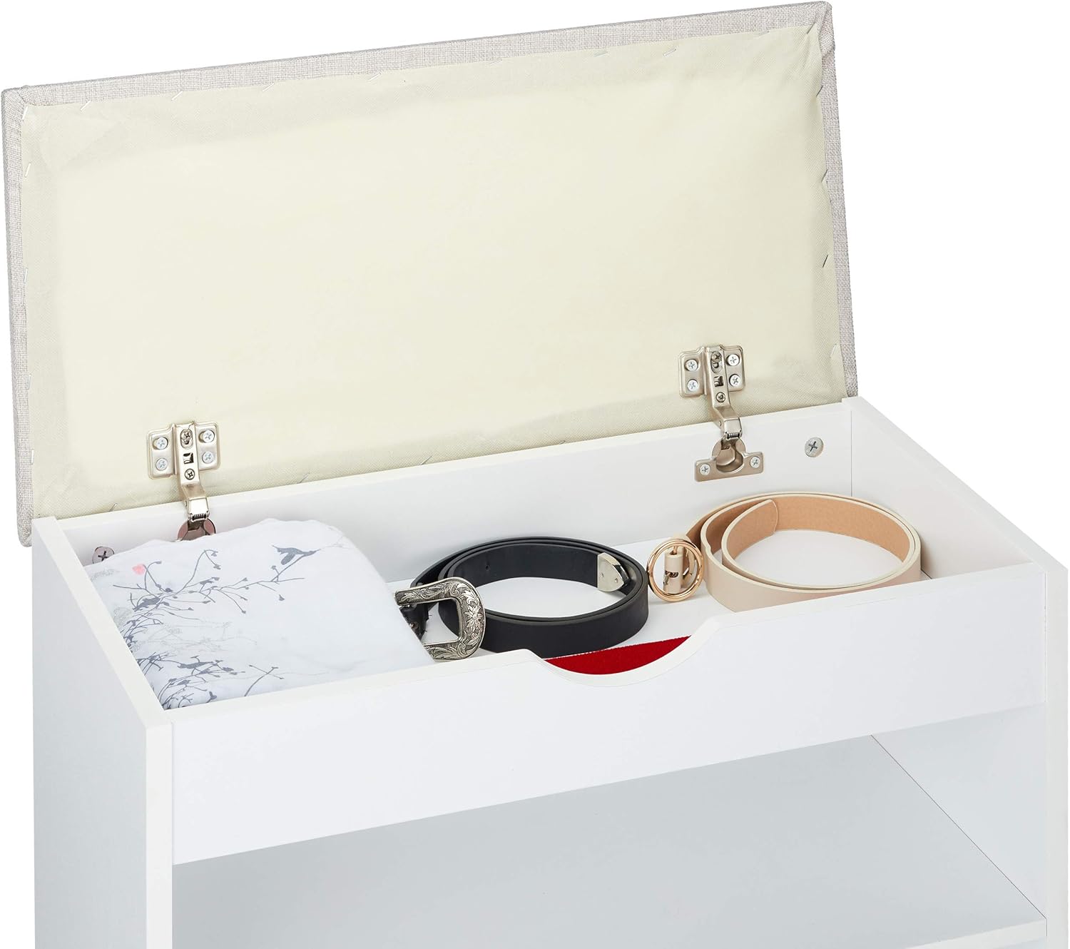 Inside the hidden storage compartment of the shoe bench, showing belts and other accessories
