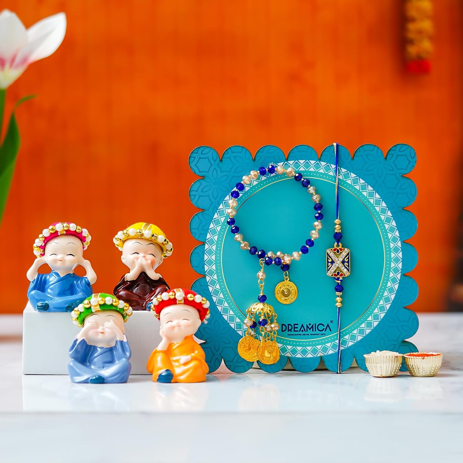Dreamica Bhaiya Bhabhi Rakhi Combo | Monk Buddha Showpiece Set with Lumba Rakhi Pair, Greeting Card & Tilak Set | Raksha Bandhan Gift Hamper for Bhaiya Bhabhi (Rakhi-181) Dreamica Bhaiya Bhabhi Rakhi Combo | Monk Buddha Showpiece Set with Lumba Rakhi Pair, Greeting Card & Tilak Set | Raksha Bandhan Gift Hamper for Bhaiya Bhabhi (Rakhi-181)