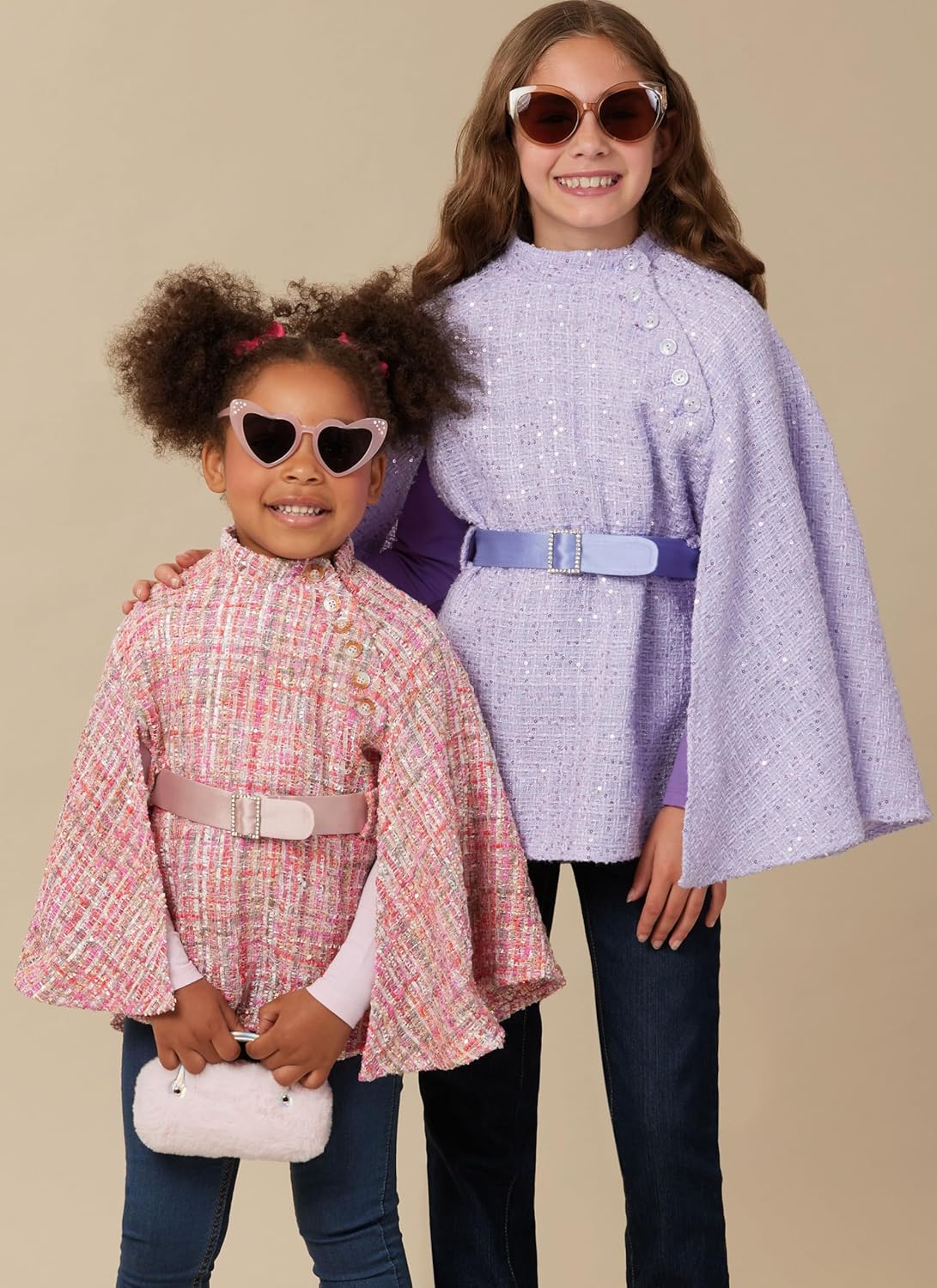 Line drawings of three cape variations: View A with a tie neck, View B with a Peter Pan collar, and View C with a stand collar and belt.