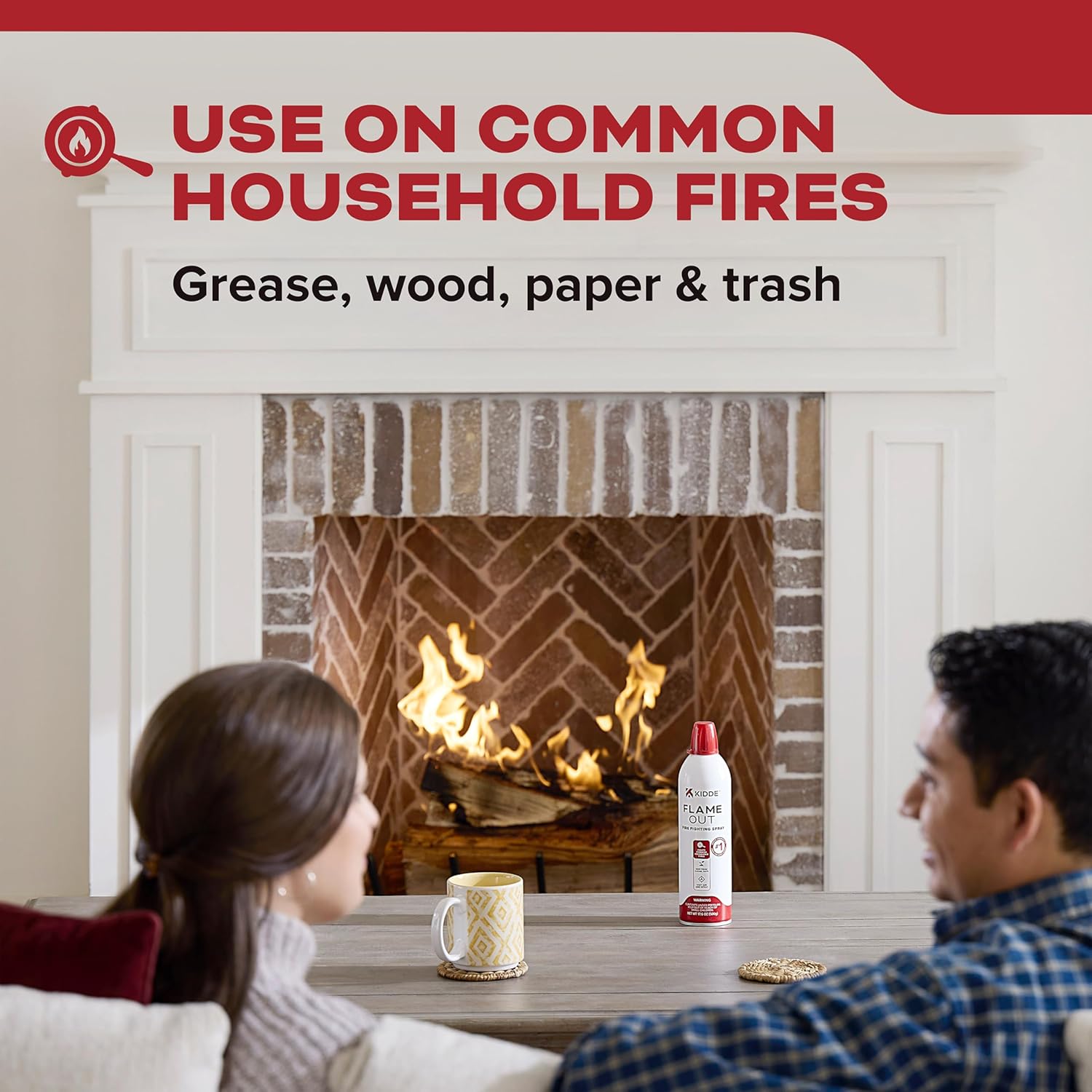 Kidde Flame Out Fire Spray on a table in front of a fireplace with a wood fire.