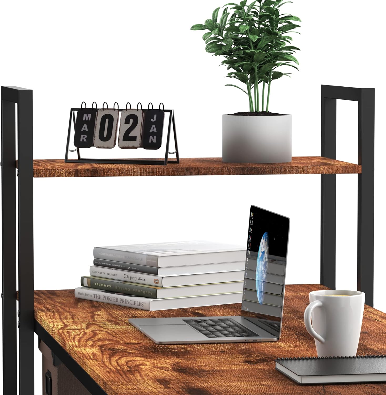 Close-up of the top shelf of the HOMIDEC desk with a plant, calendar, and laptop