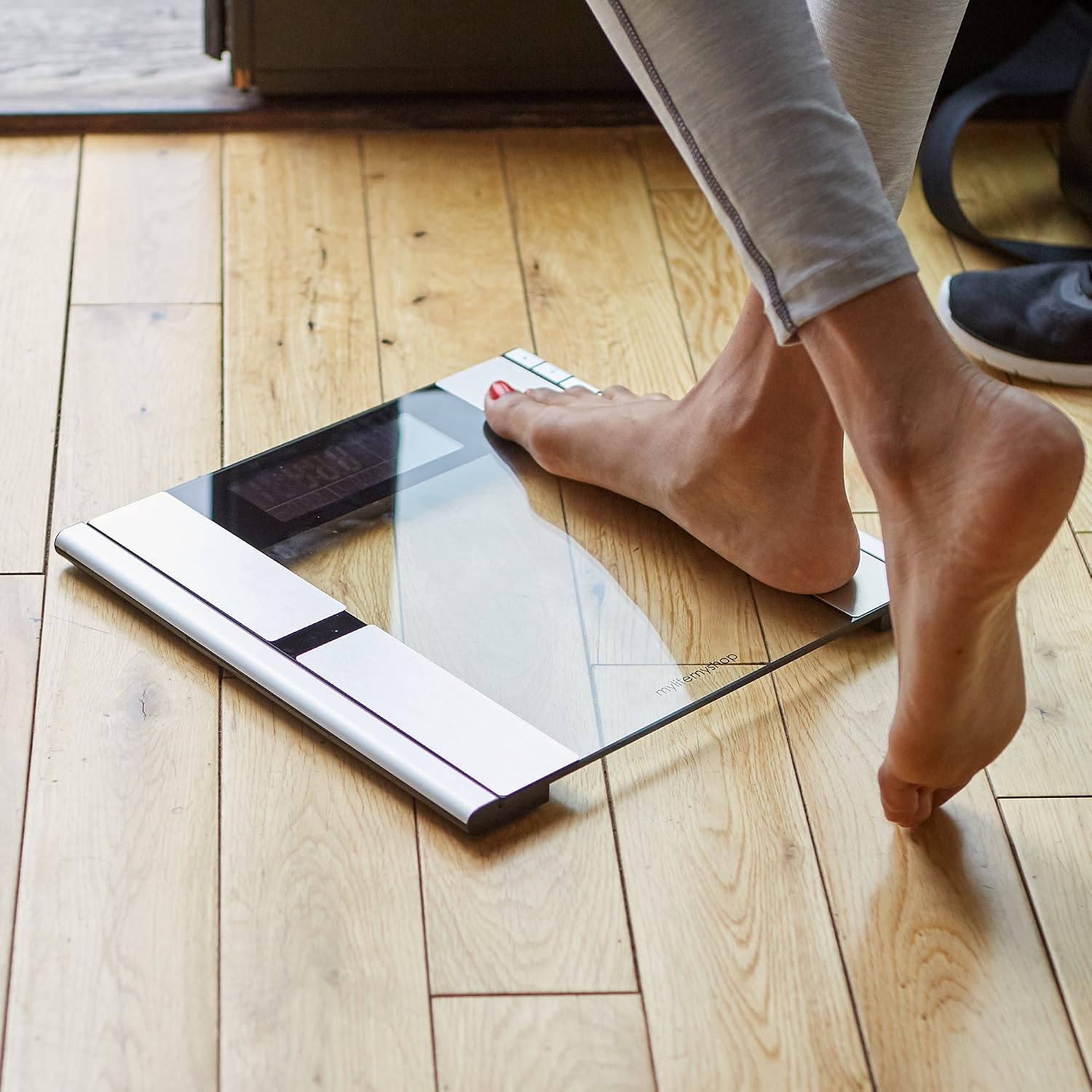 Person stepping onto the Vanity Planet Work It Digital Scale with bare feet