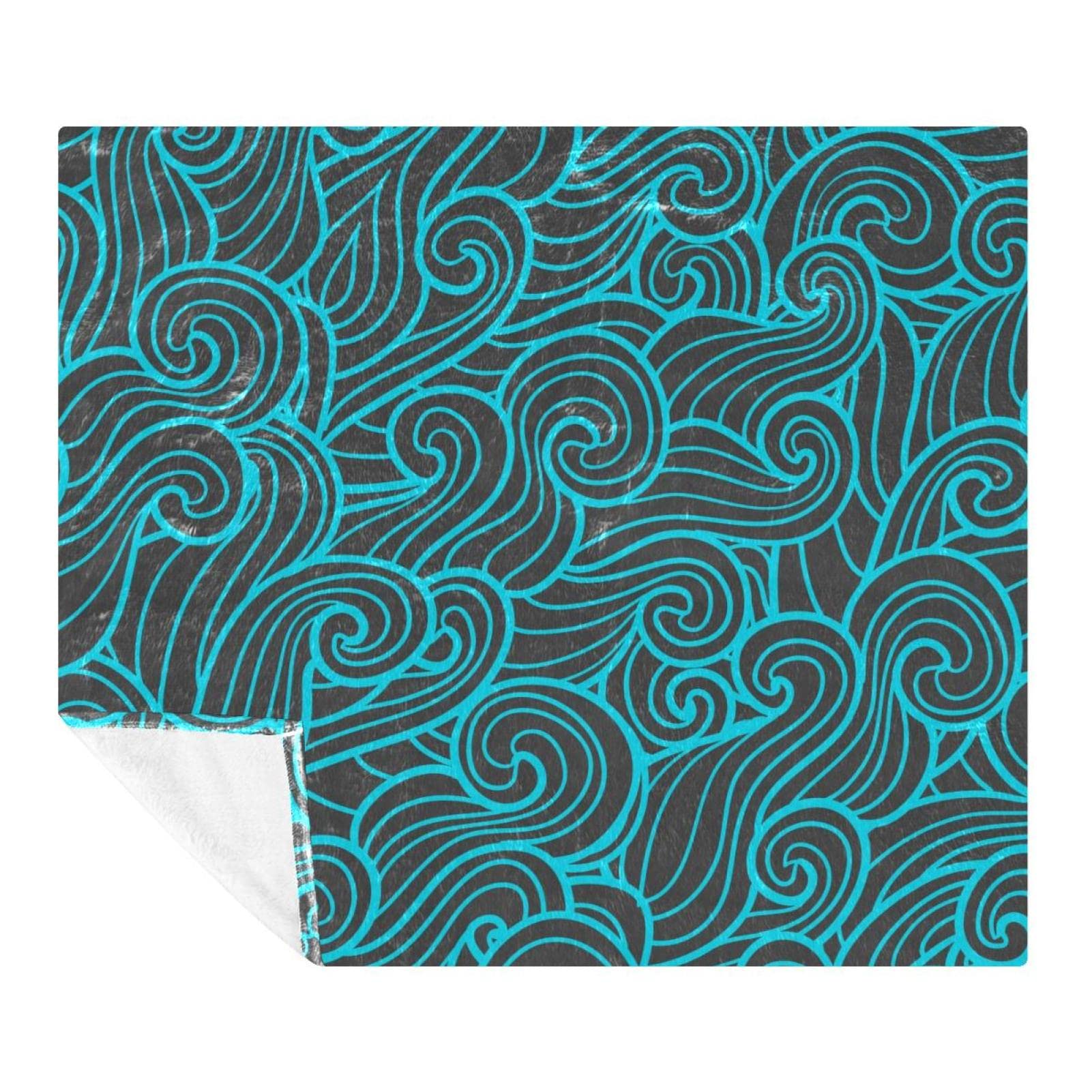 Couverture douce motif vagues pour cocooning sur canapé et voyage